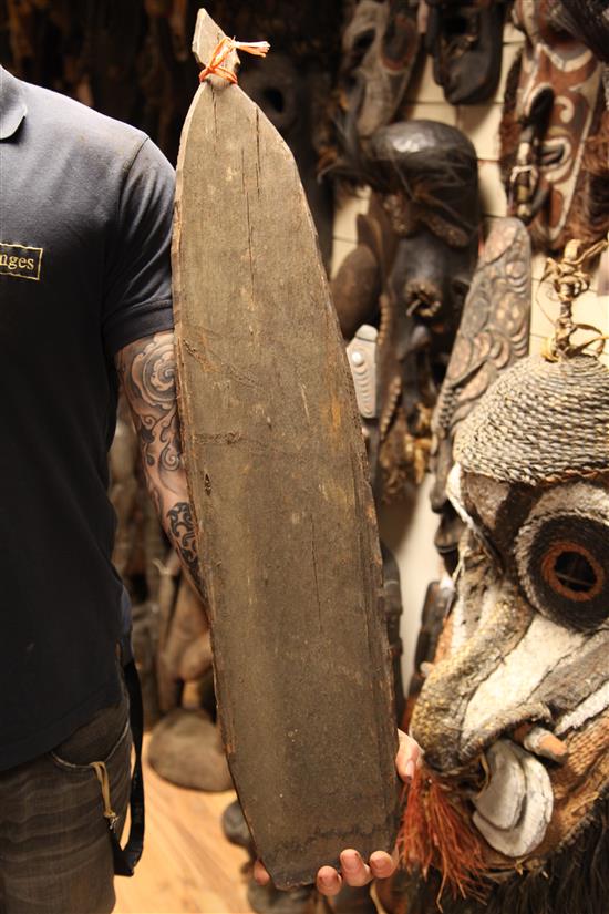 A Sepik River double mask shield, two garra masks, bullroarer etc (5)